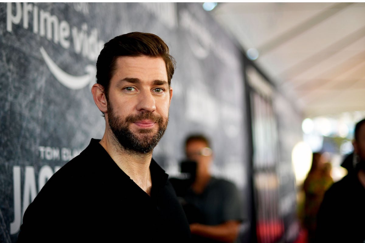 John Krasinski poses for pictures in front of the Amazon Prime Video logo at the premiere of "Jack Ryan"