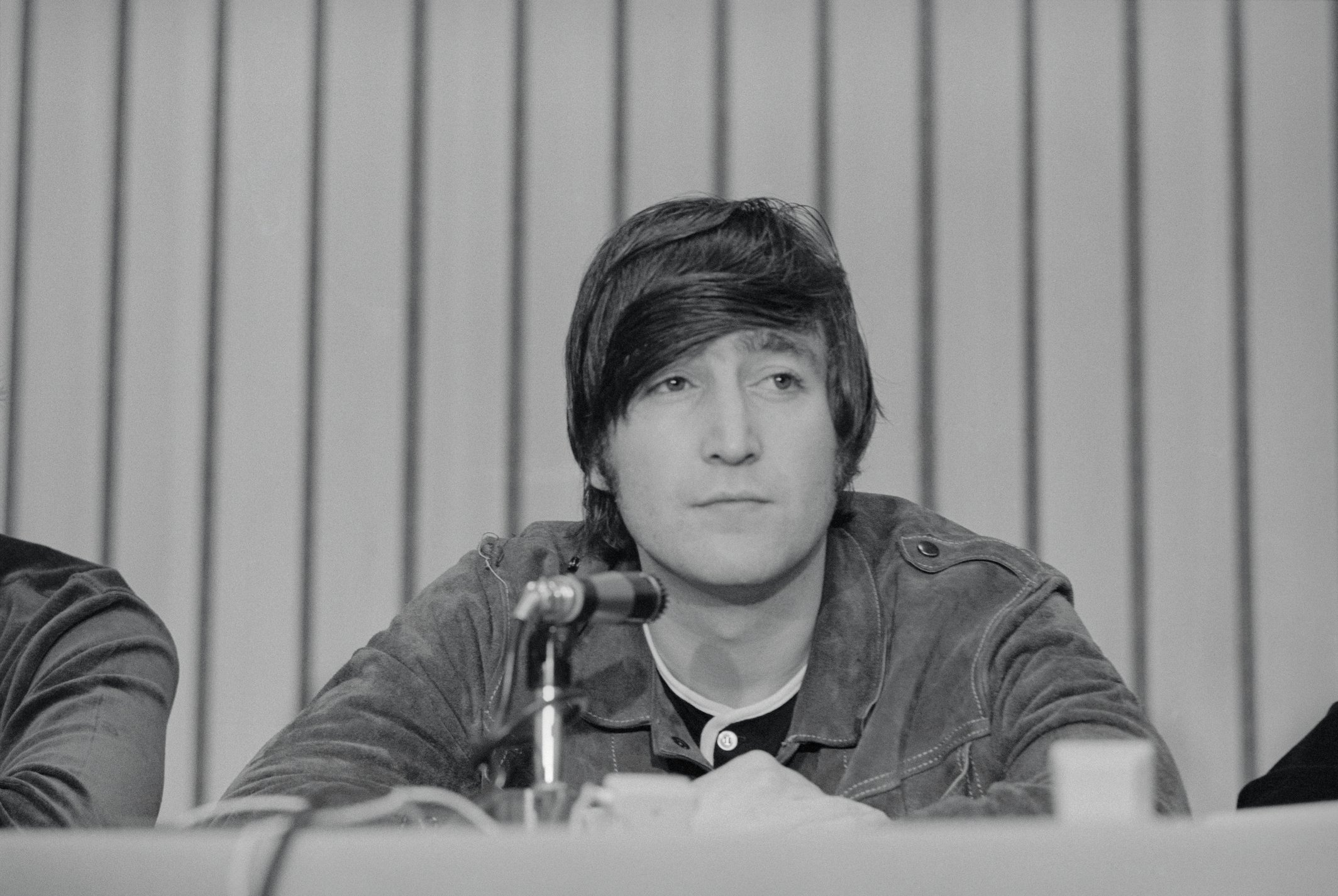 John Lennon attends a press conference for The Beatles after a performance in Portland