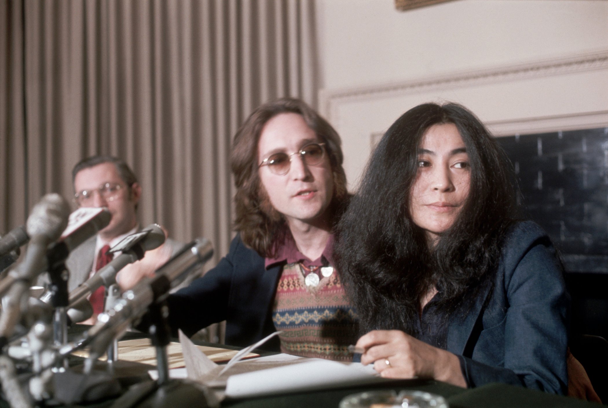 John Lennon, a former "Beatle" with wife, Yoko Ono, during a press conference