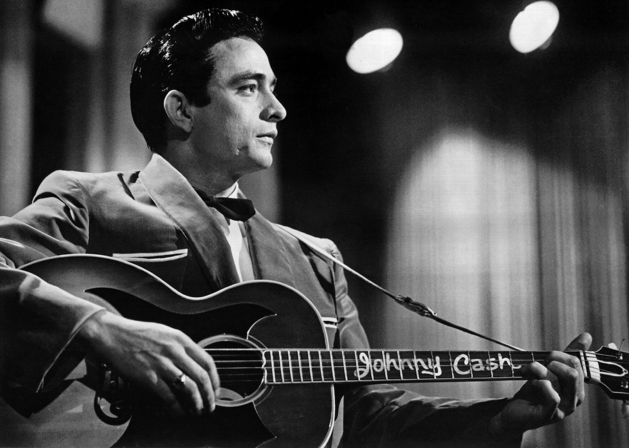 Johnny Cash performing with his acoustic guitar during a Sun Records publicity event in 1957.