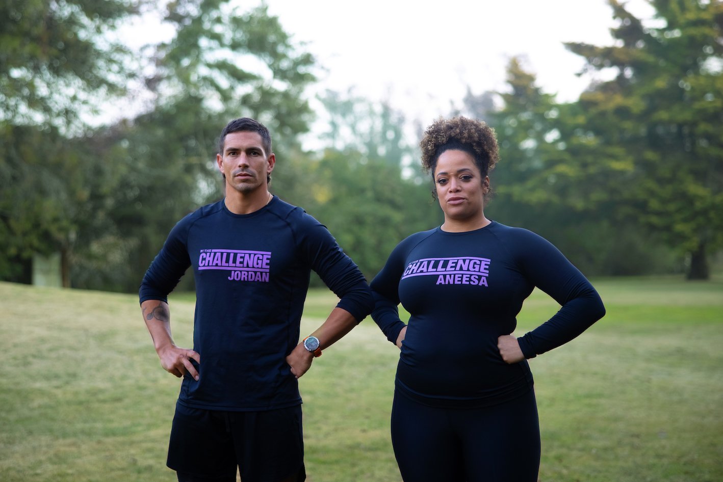Jordan Wiseley and Aneesa Ferreira standing in their uniforms with their hands on their hips for 'The Challenge' Season 38