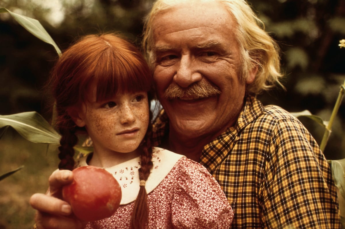 Kami Cotler, with pigtails, and Will Geer, holding an apple, on 'The Waltons'