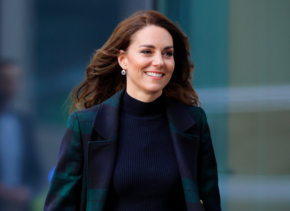 Kate Middleton smiles as she walks.