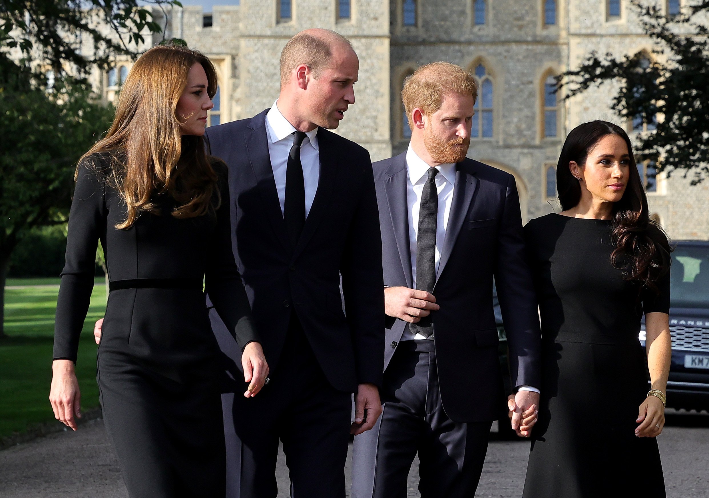Kate Middleton and Prince William walk alongside Prince Harry and Meghan Markle during the walkabout before the funeral of Queen Elizabeth II.