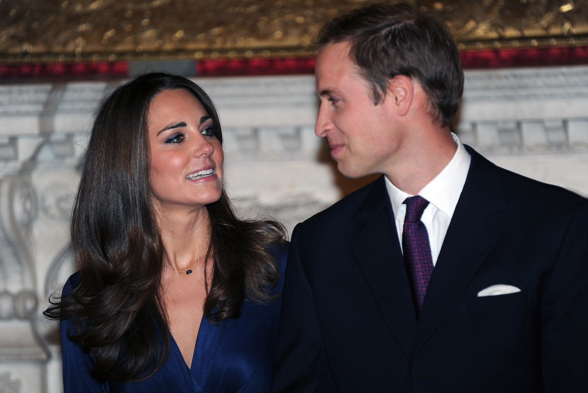 Kate Middleton, who said there was an 'awkward situation' with her mother, Carole Middleton, after Prince William proposed in her and Prince William's 2010 engagement interview, look at each other as they pose for photos following their engagement announcement 