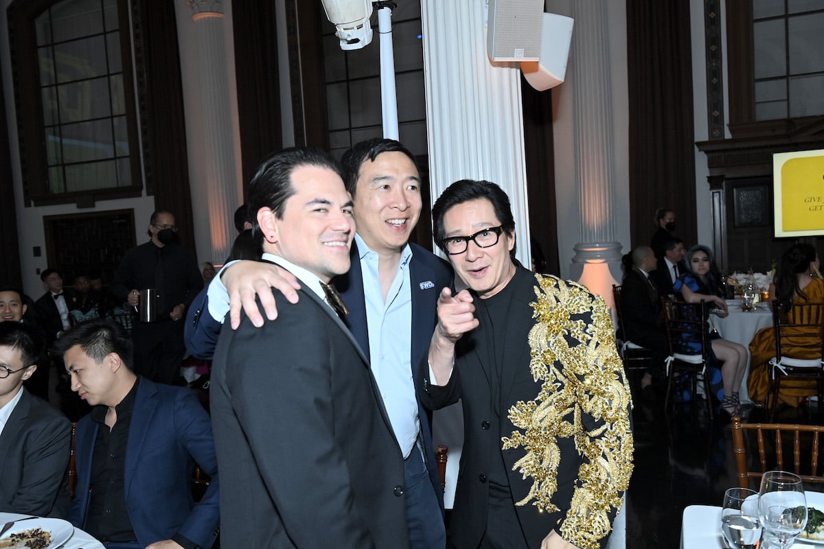 Jonathan Wang, Andrew Yang, and Ke Huy Quan smile at a 2022 gala