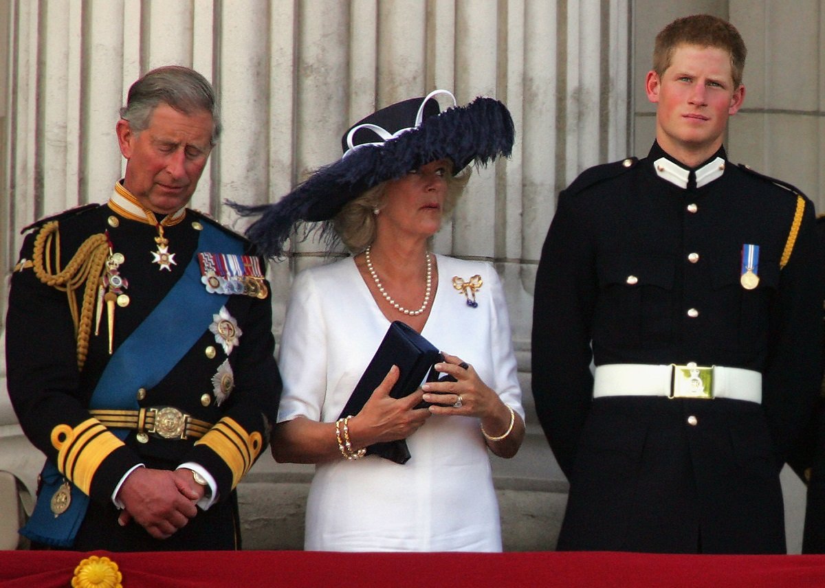 King Charles III, Camilla Parker Bowles, and Prince Harry watch the flypast from the Buckingham Palace balcony