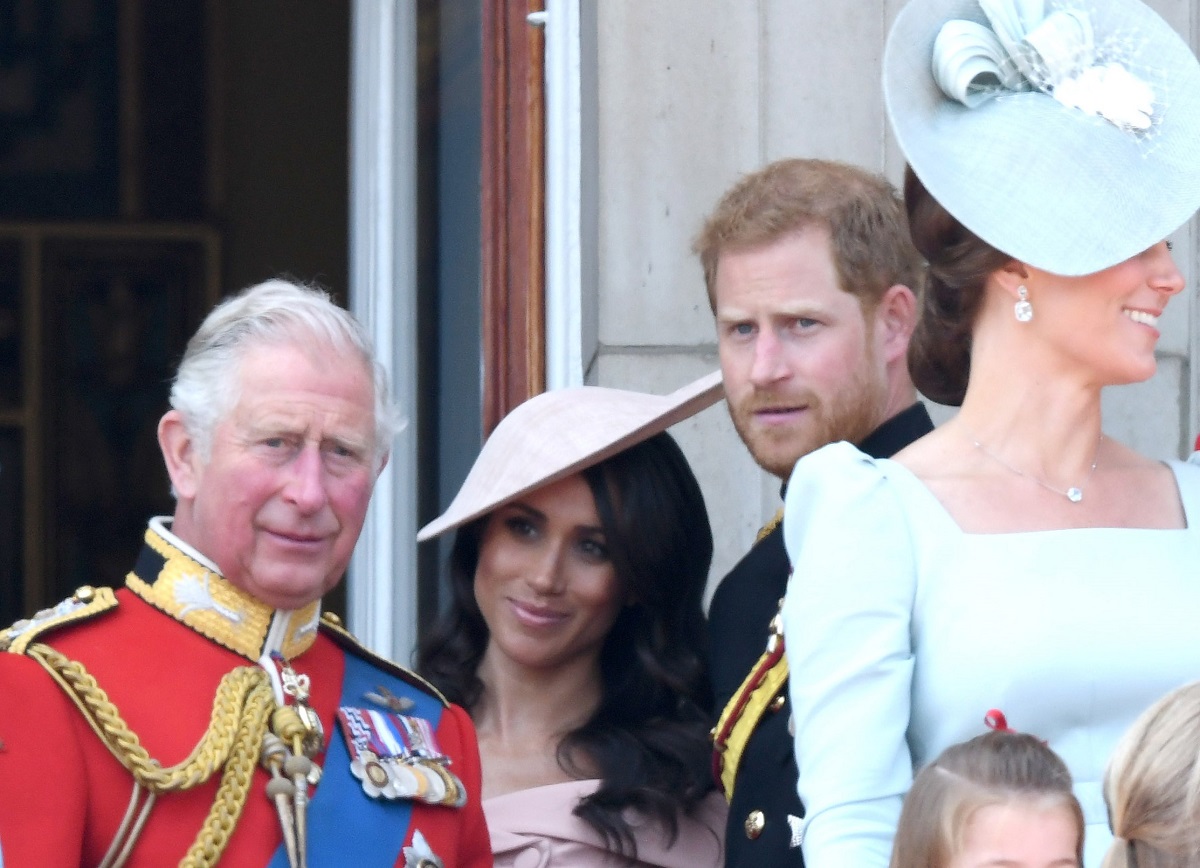 King Charles III, Meghan Markle, and Prince Harry standing on the balcony of Buckingham Palace during Trooping The Colour 2018