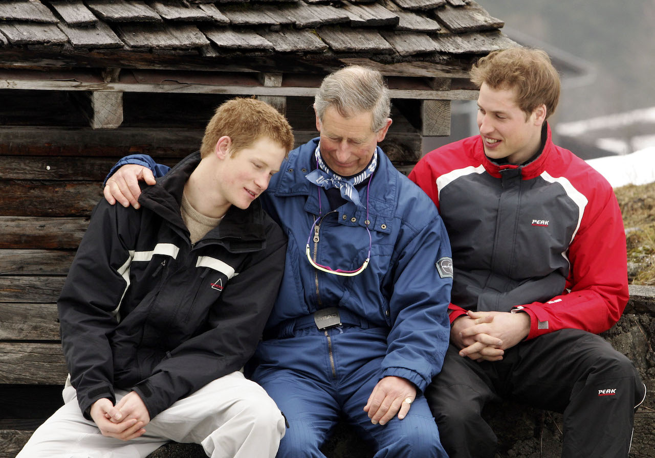 King Charles (C) poses with his sons Prince William (R) and Prince Harry (L) during the royal family's ski break at Klosters on March 31, 2005, in Switzerland.