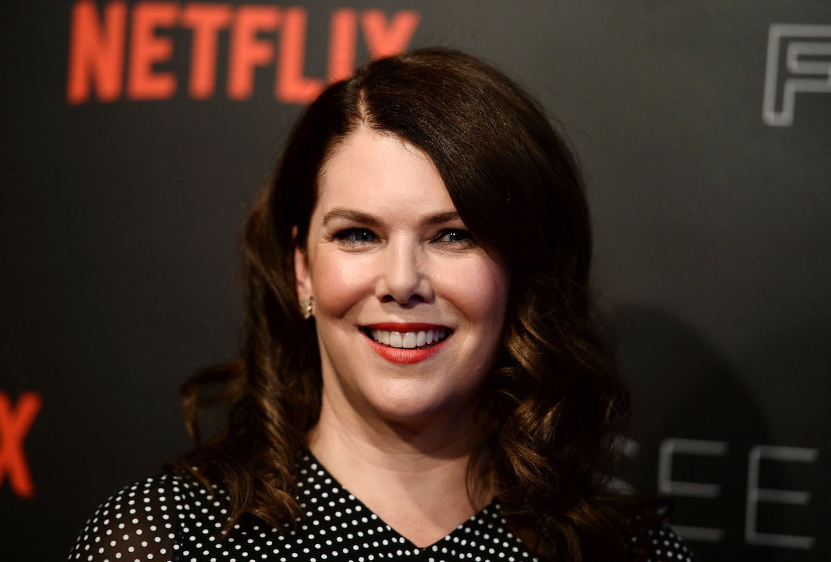Actor Lauren Graham poses for the camera in front of a Netflix logo.
