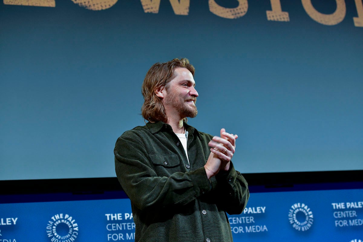 Luke Grimes puts his hands together at an event promoting 