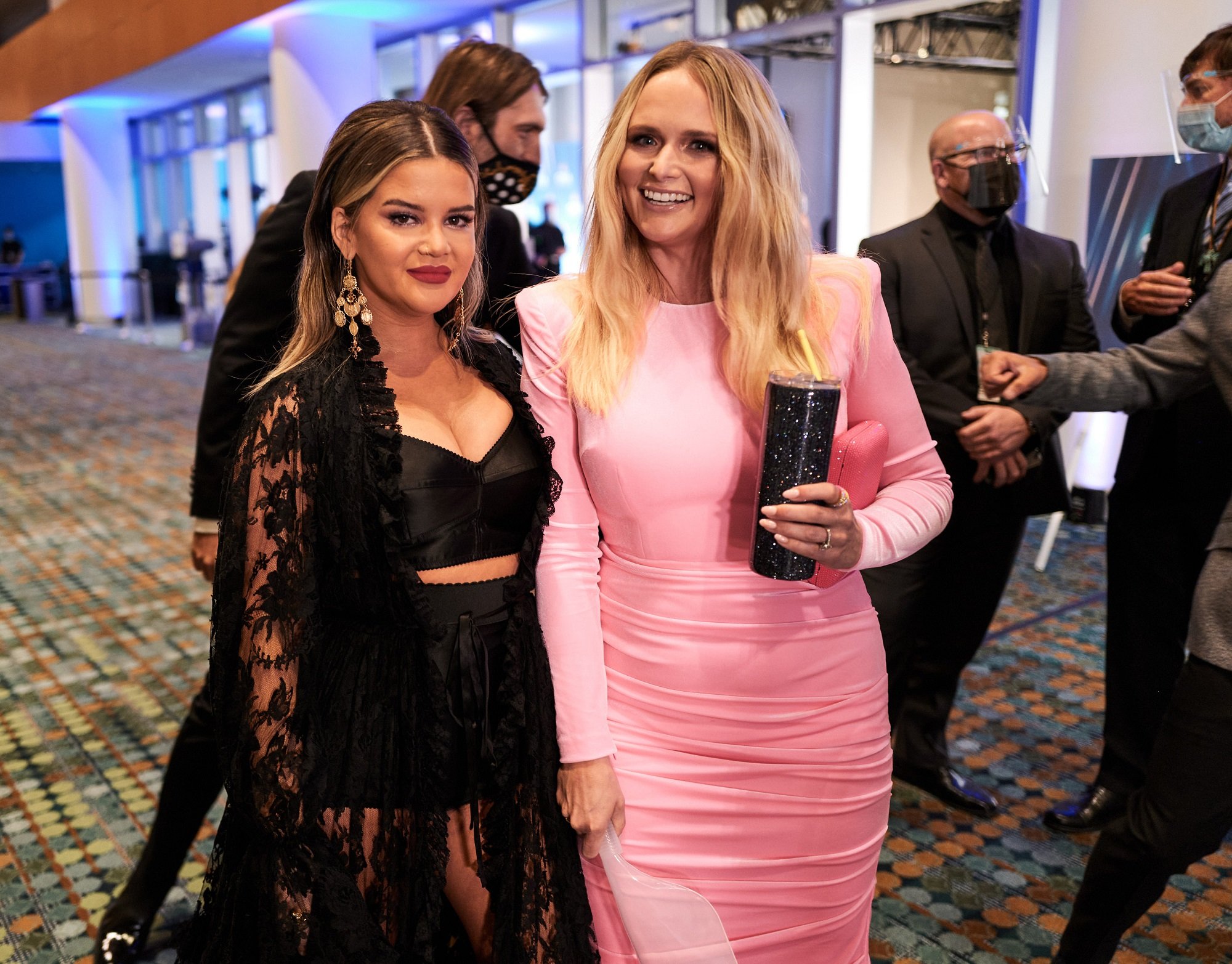 Maren Morris and Miranda Lambert stand side-by-side and smile at the camera