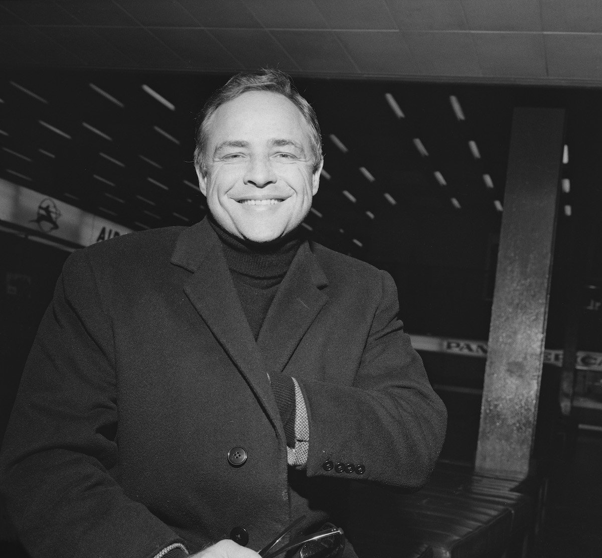 Marlon Brando smiles in a black and while photo taken in London, 1967.