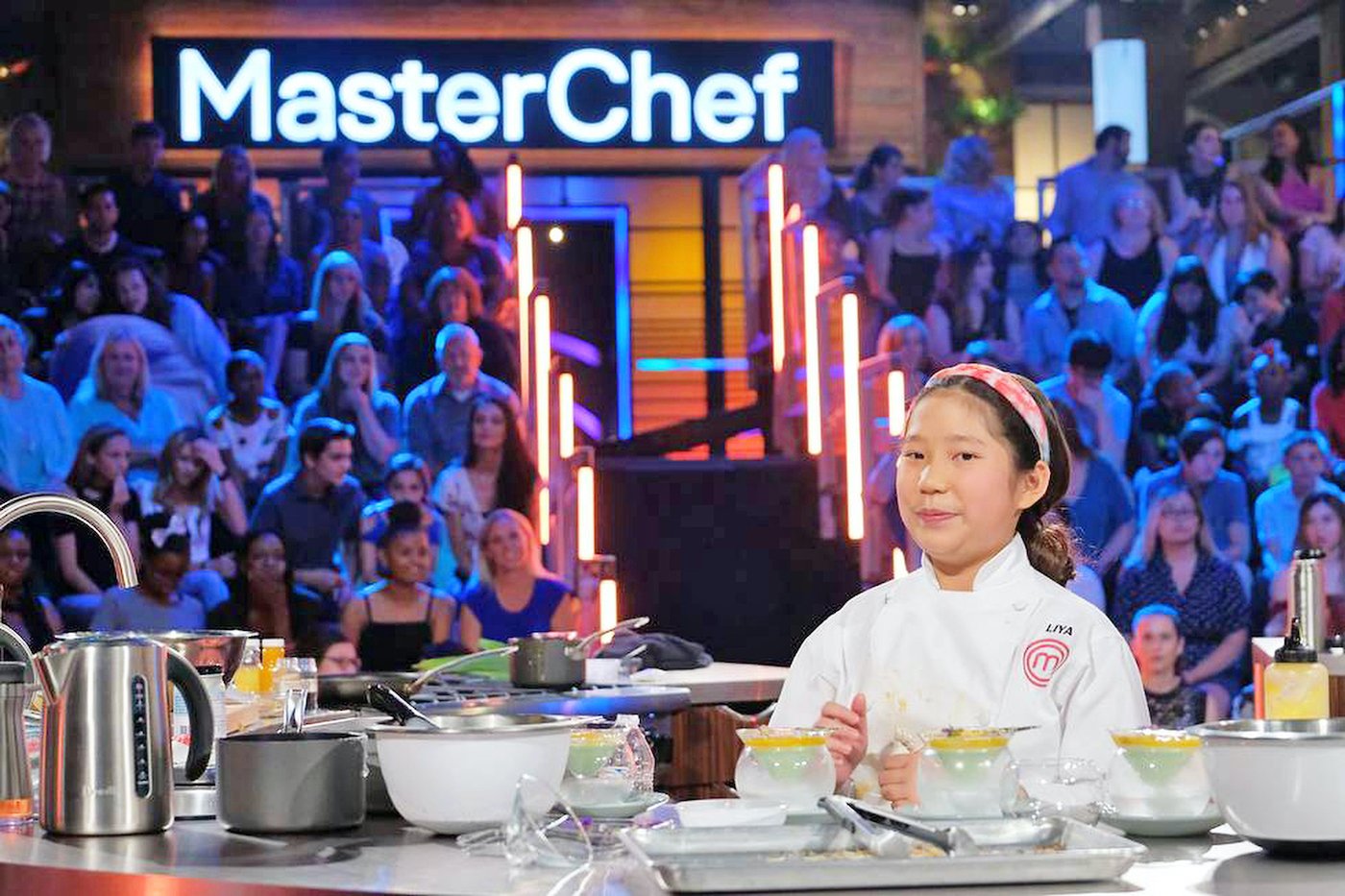 MasterChef Junior Liya Chu stands in front of her creations on the show