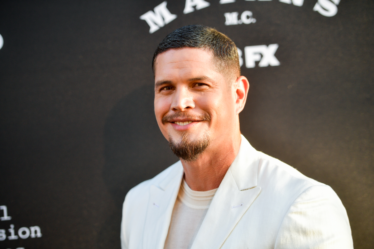 J.D. returns for Mayans MC Season 5. Pardo wears a white suit jacket and white shirt underneath.