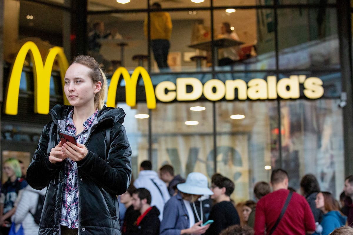 A girl waiting in line to pick up an order at the McDonald's restaurant