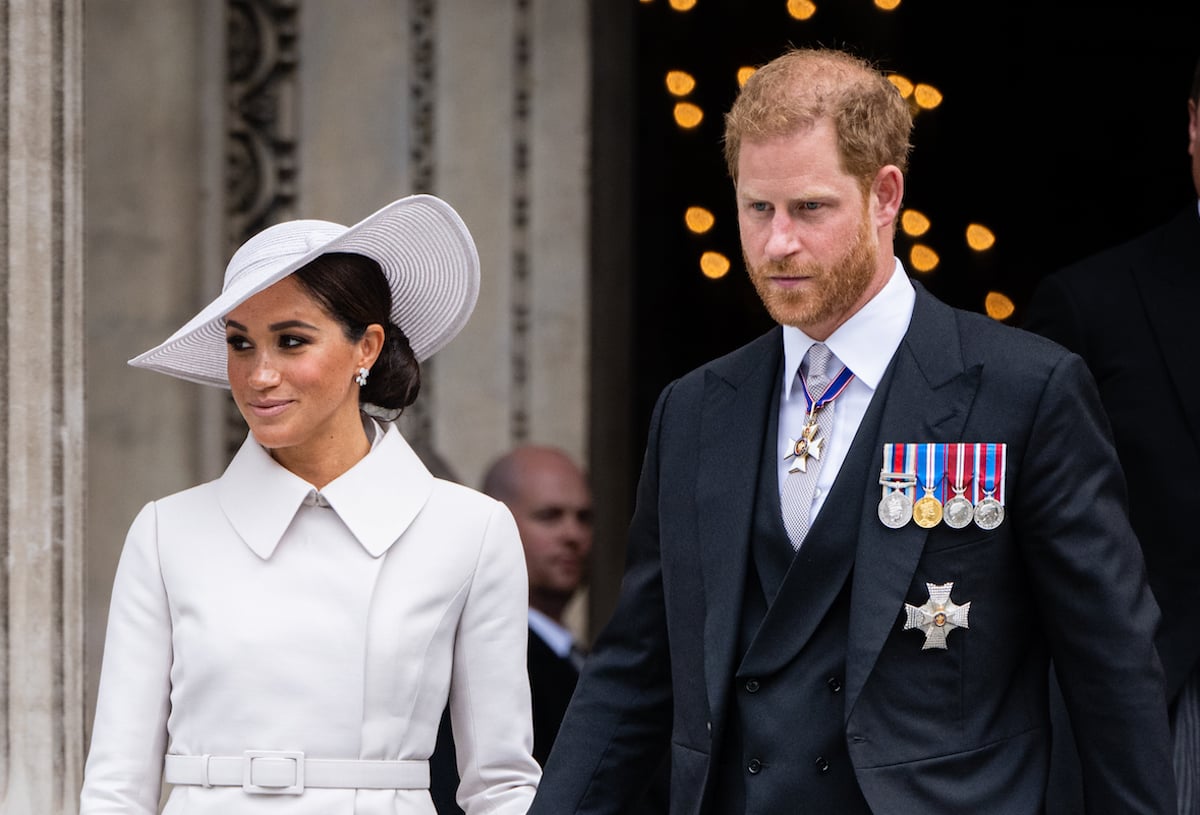 Meghan Markle and Prince Harry, who are said to be 'winning' in spite of 'Spare' popularity dip, hold hands