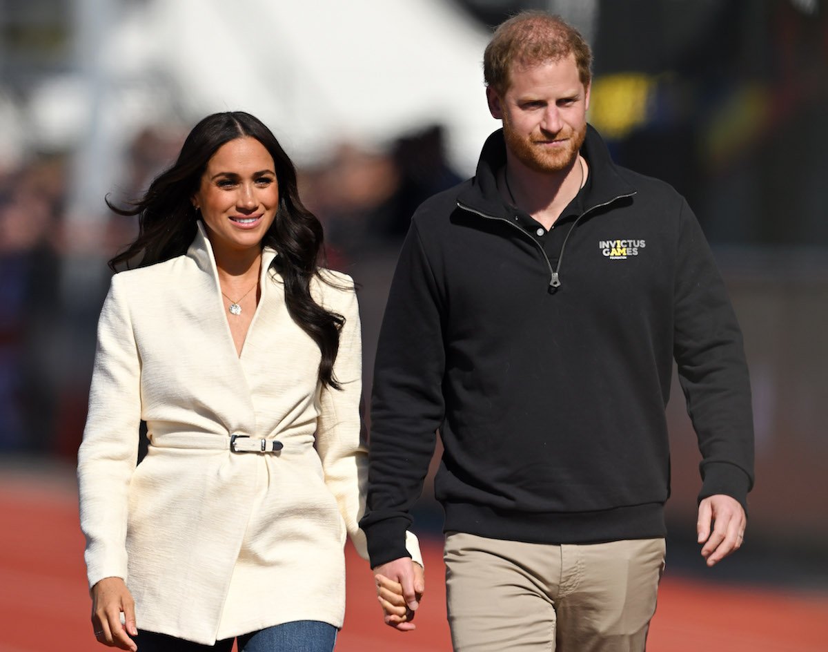 Meghan Markle and Prince Harry, who shared his and Meghan Markle's In-N-Out Burger order, hold hands