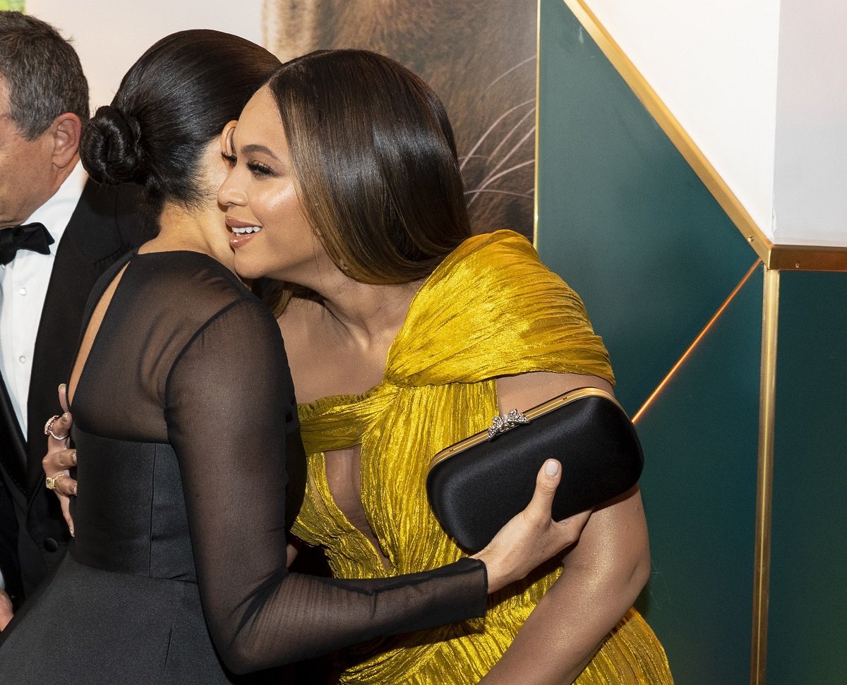 Meghan Markle, who reportedly thought she would be the Beyoncé of the U.K., greets the singer with a hug at the European Premiere of Disney's 'The Lion King'