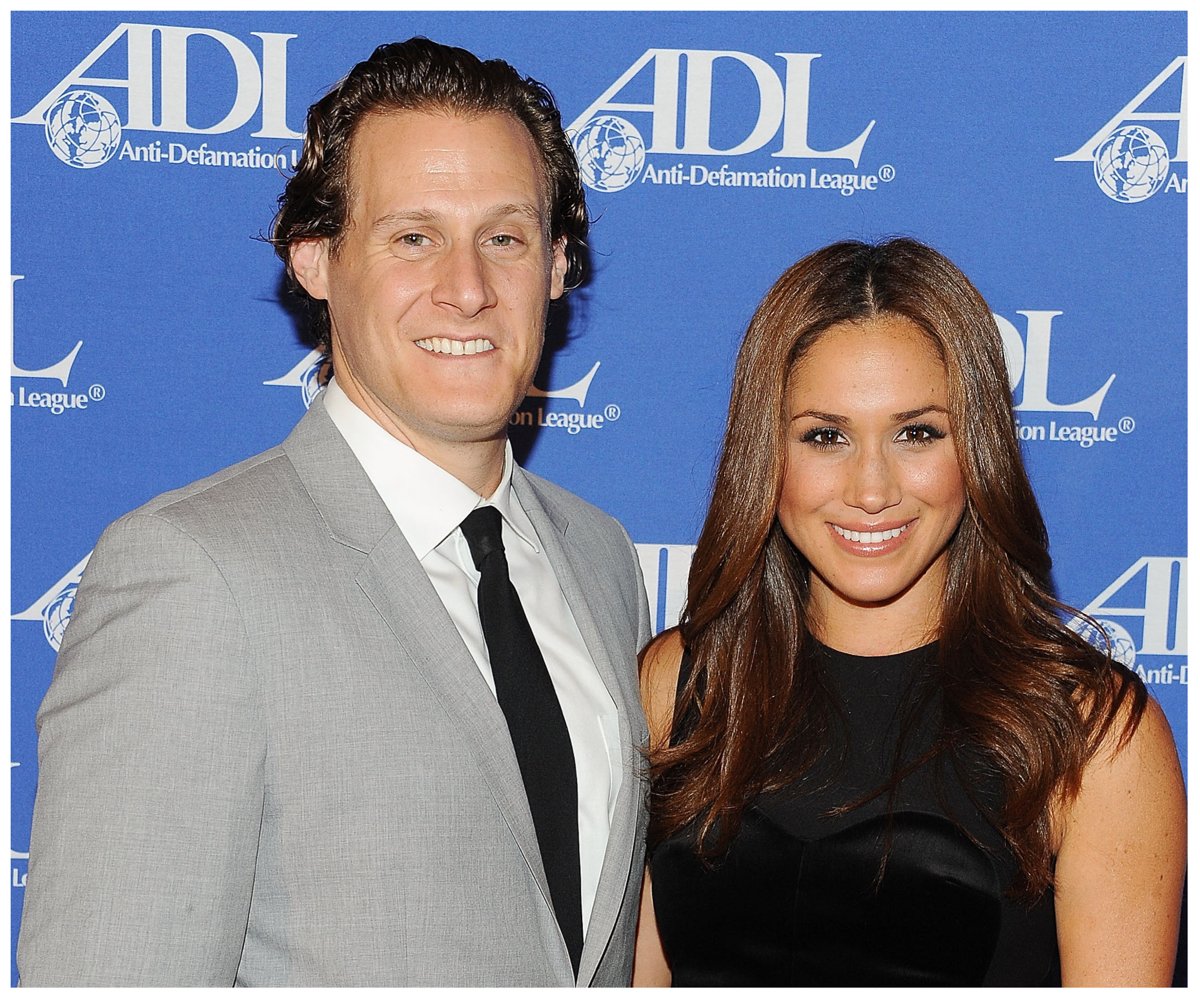 Meghan Markle smiles and poses with her ex-husband, Trevor Engelson, at an event.