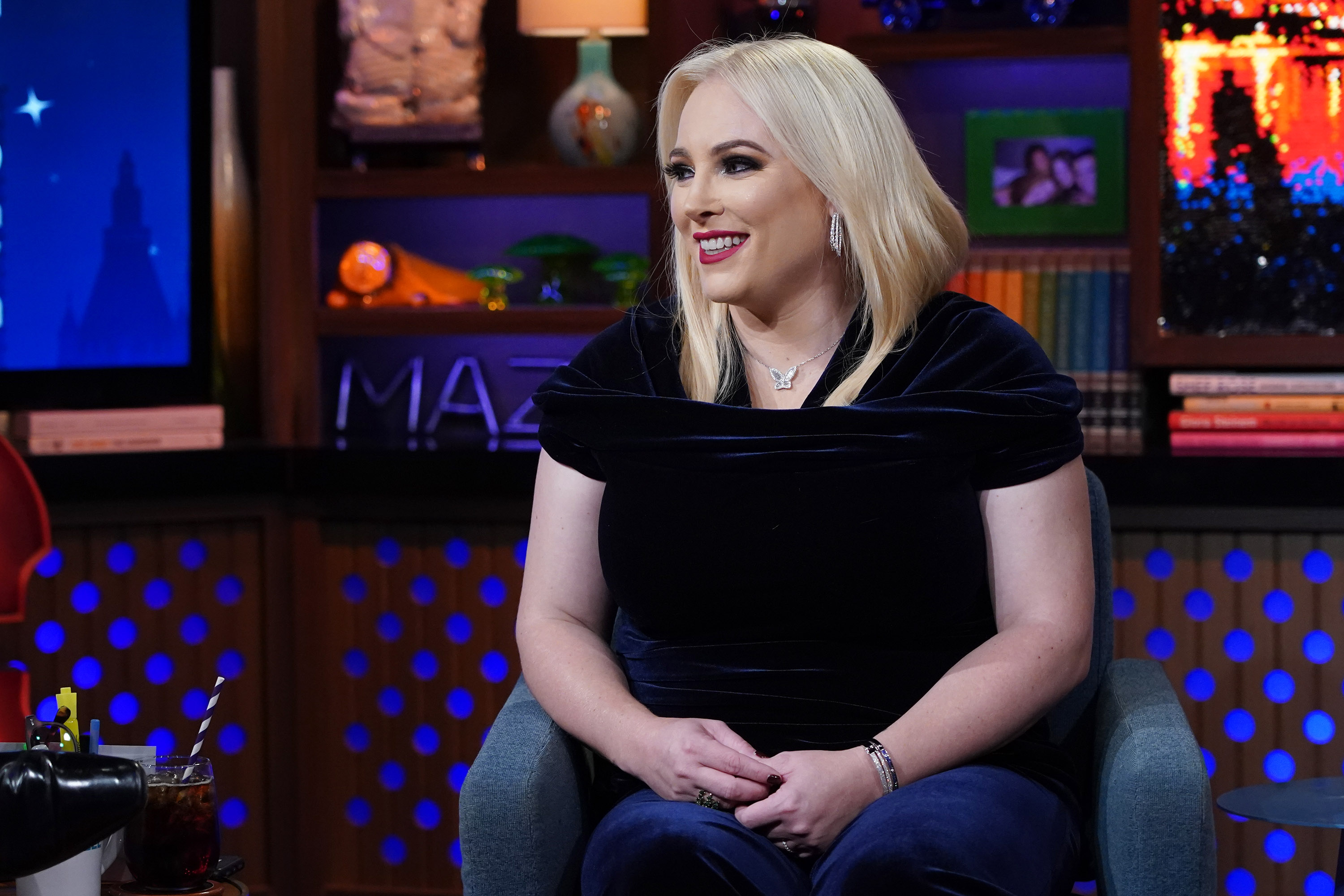Meghan McCain smiles while wearing a black short-sleeved shirt and jeans