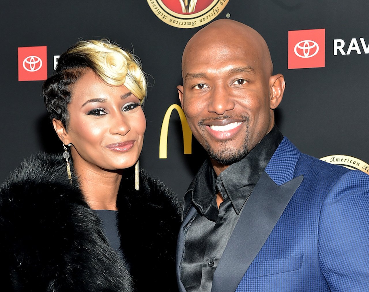 Melody and Martell Holt smile together on the red carpet
