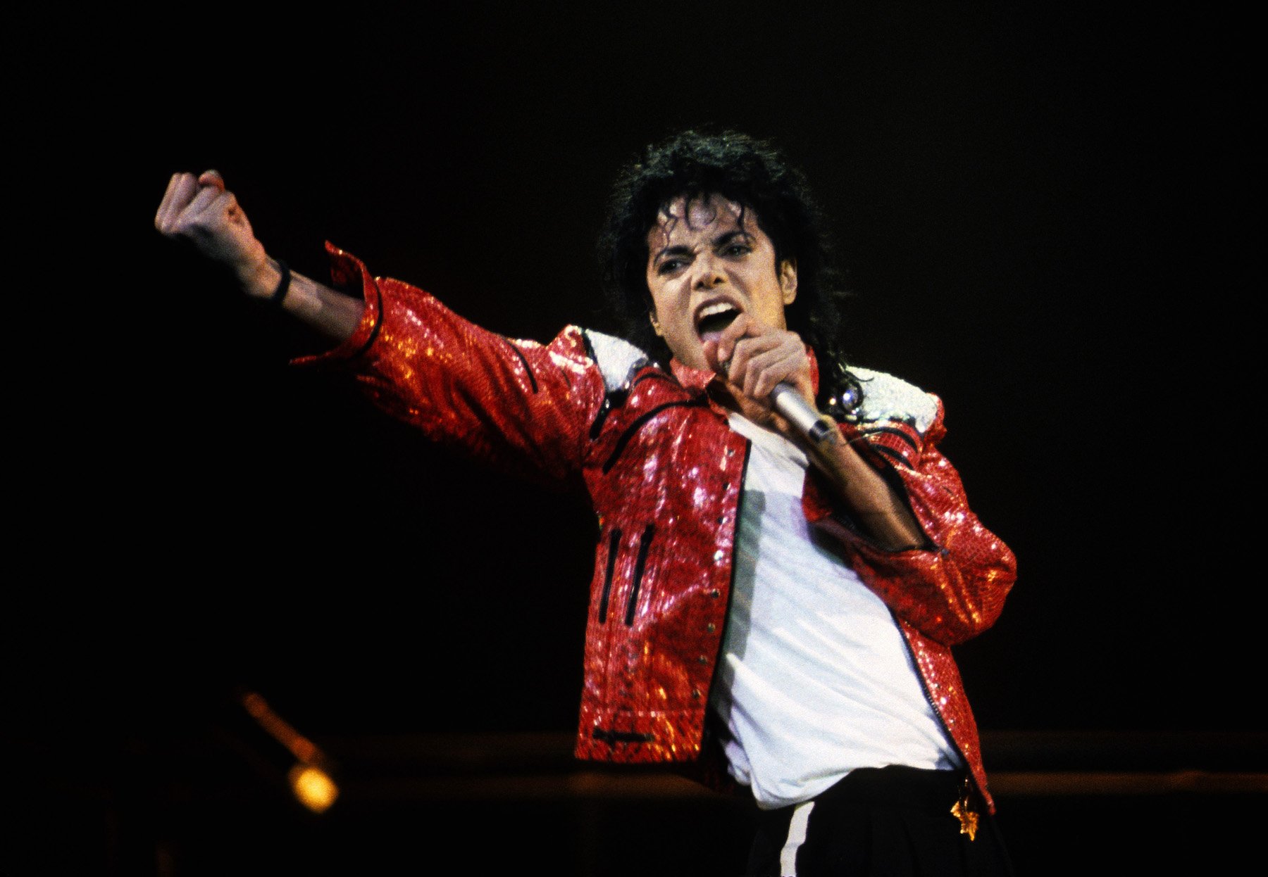 Michael Jackson, whose nephew will play him in a biopic, wearing a red jacket on stage