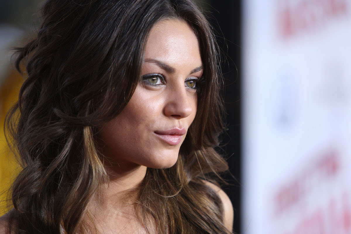 A close up of Mila Kunis' face at a movie premiere event.