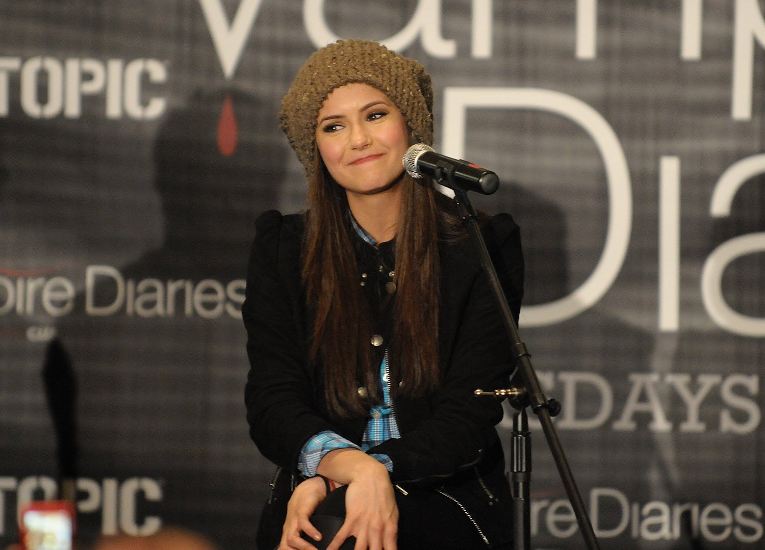 Nina Dobrev sitting at an event for 'The Vampire Diaries'