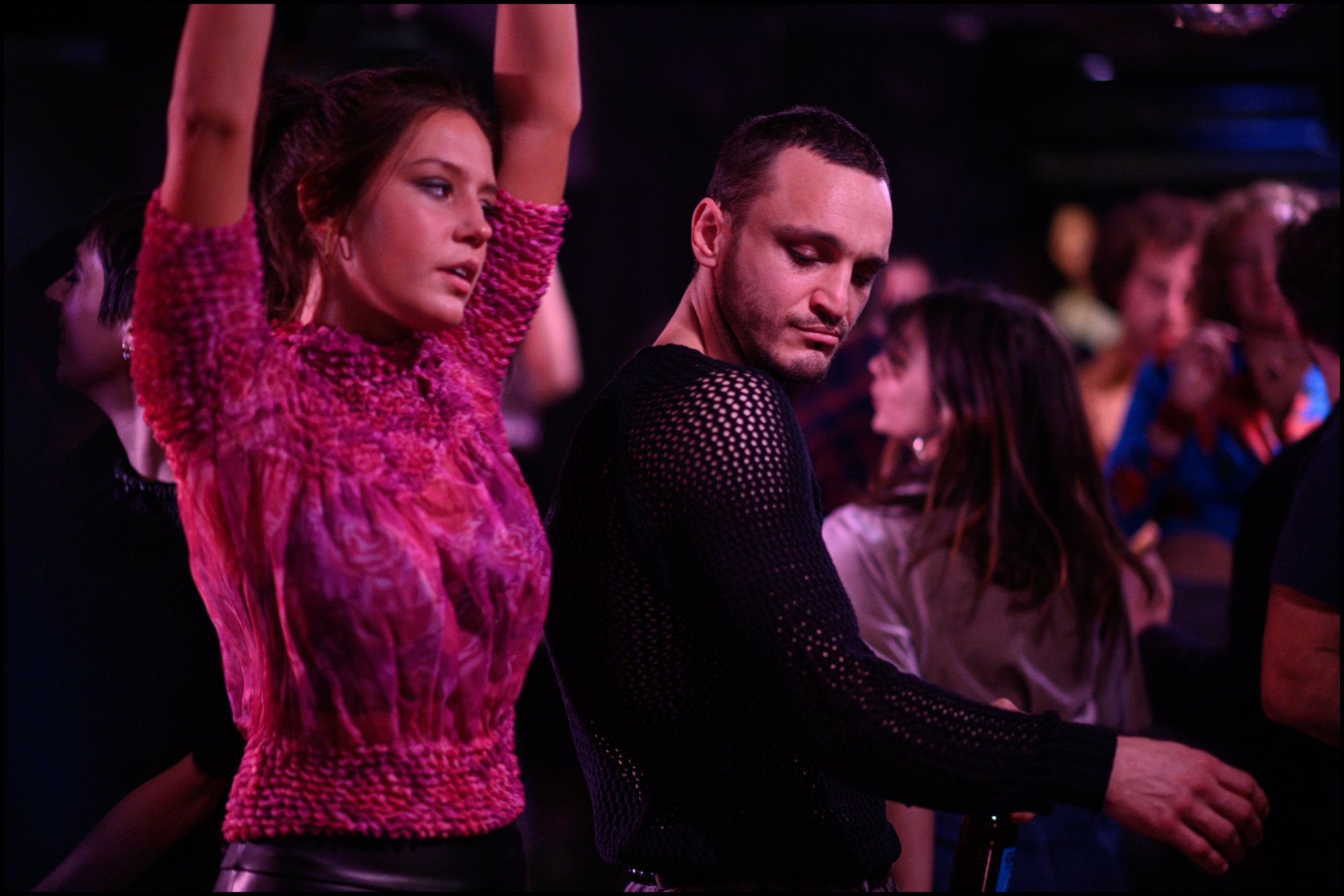 'Passages' Adèle Exarchopoulos as Agathe and Franz Rogowski as Tomas dancing next to each other in a crowd of people