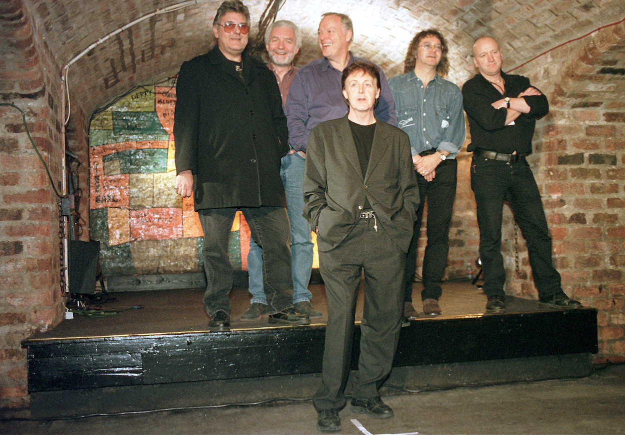 Paul McCartney (front center) stands in front of Pink Floyd guitarist David Gilmour at Liverpool's Cavern Club in 1999.