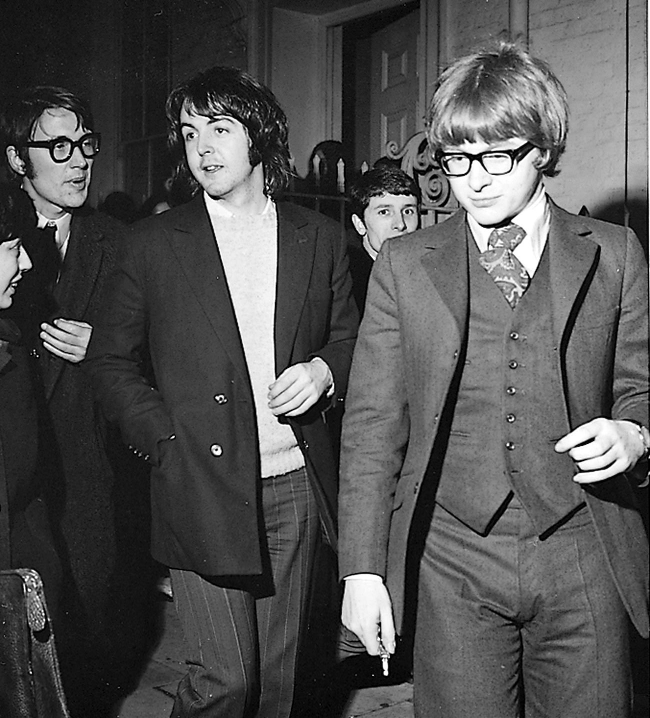 Paul McCartney and Peter Asher in suits in 1969.