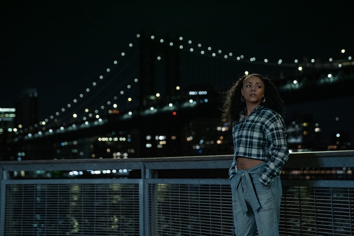 Alix Lapri as Effie Morales standing next to the water looking at the bridge in 'Power Book II: Ghost'