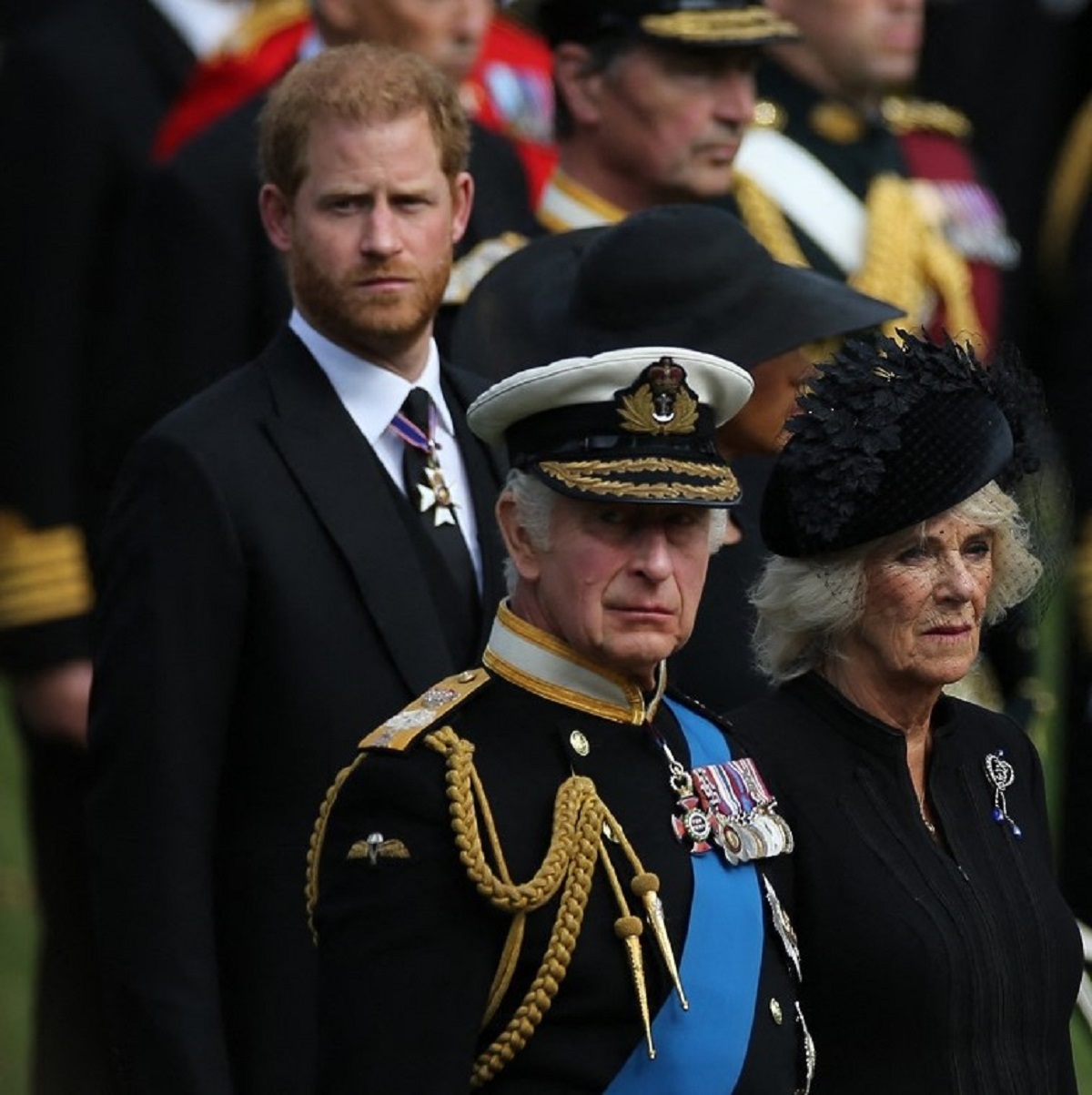 Prince Harry, King Charles III, and Camilla Parker Bowles look at members of the Bearer Party transferring the coffin of Queen Elizabeth II