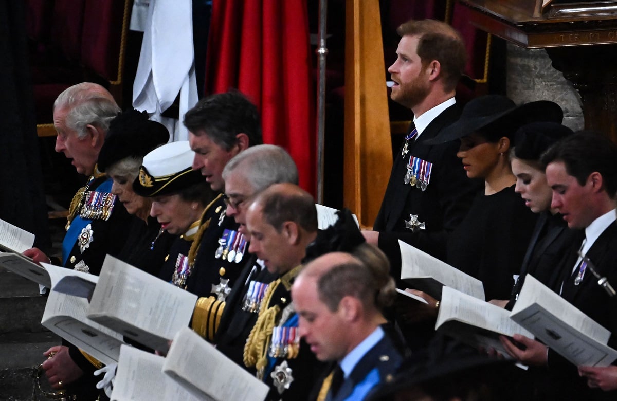 Prince Harry, King Charles III, and other members of the royal family singing hymns during Queen Elizabeth II's funeral at Westminster Abbey
