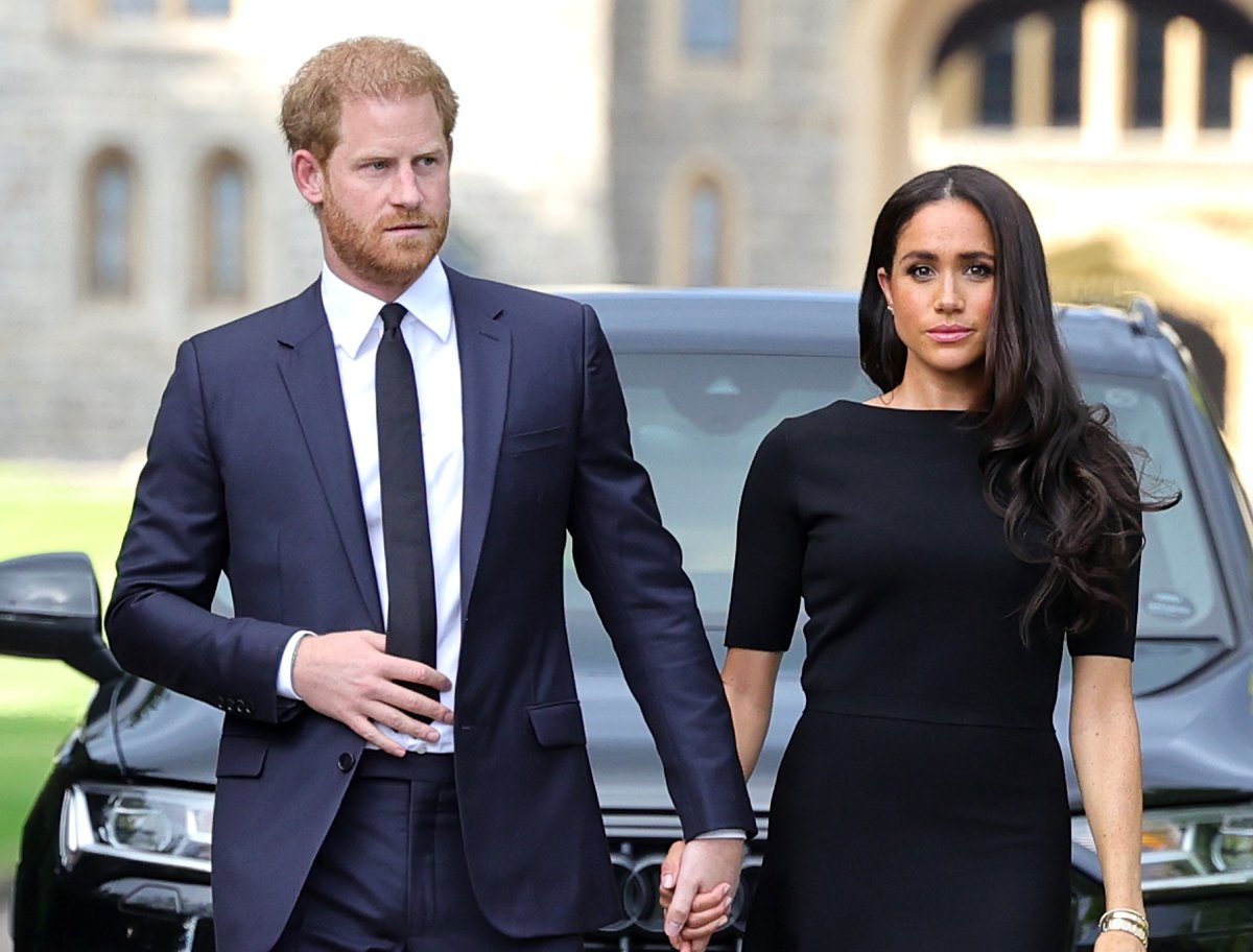 Prince Harry, Duke of Sussex, and Meghan Markle, Duchess of Sussex arrive on the long Walk at Windsor Castle arrive to view flowers and tributes to HM Queen Elizabeth on September 10, 2022 in Windsor, England. Crowds have gathered and tributes left at the gates of Windsor Castle to Queen Elizabeth II, who died at Balmoral Castle on 8 September, 2022
