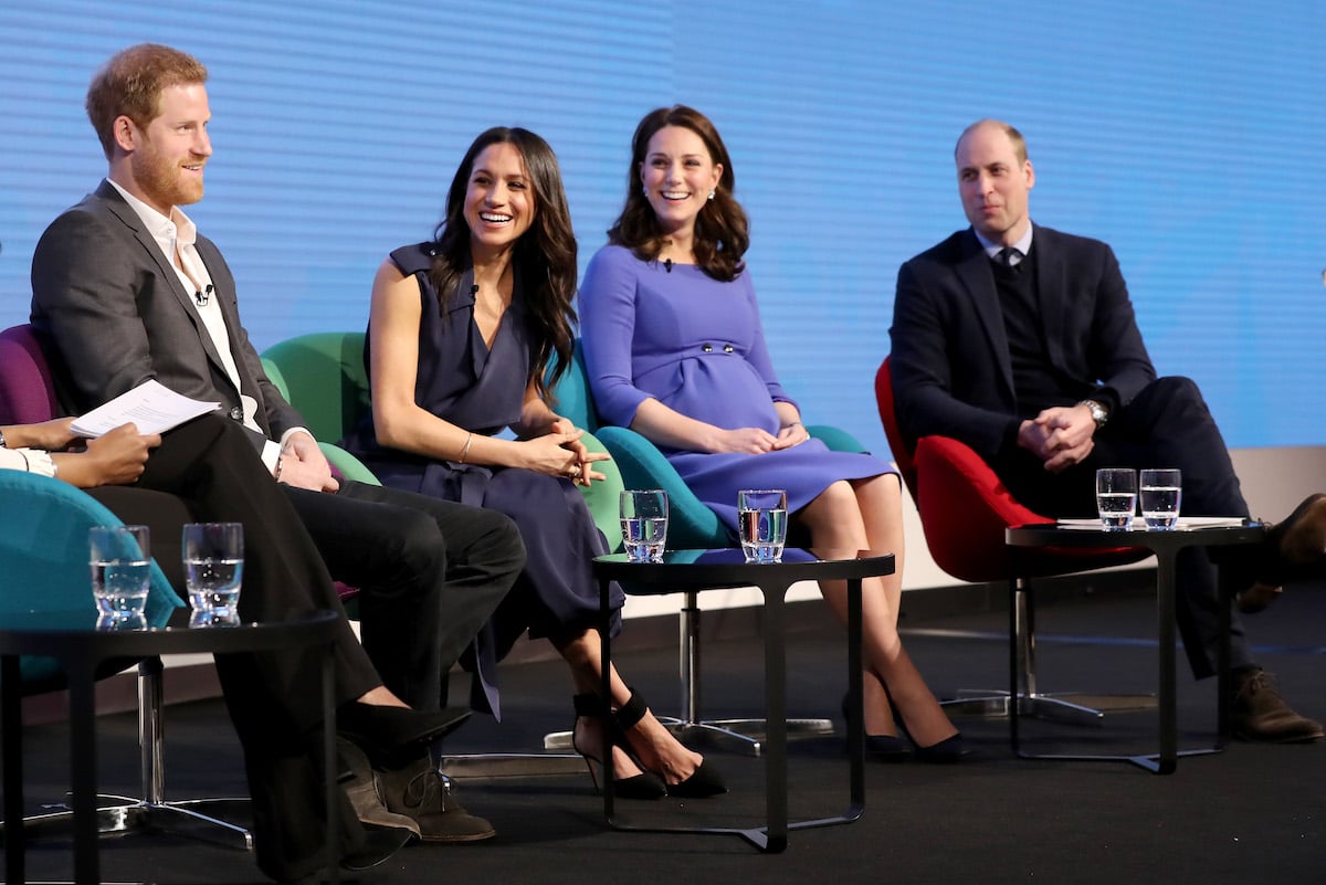 Prince Harry, who claimed Kate Middleton 'grimaced' when Meghan Markle borrowed her lip gloss, sits next to Meghan Markle, Kate Middleton, and Prince William at the Royal Foundation Forum in 2018