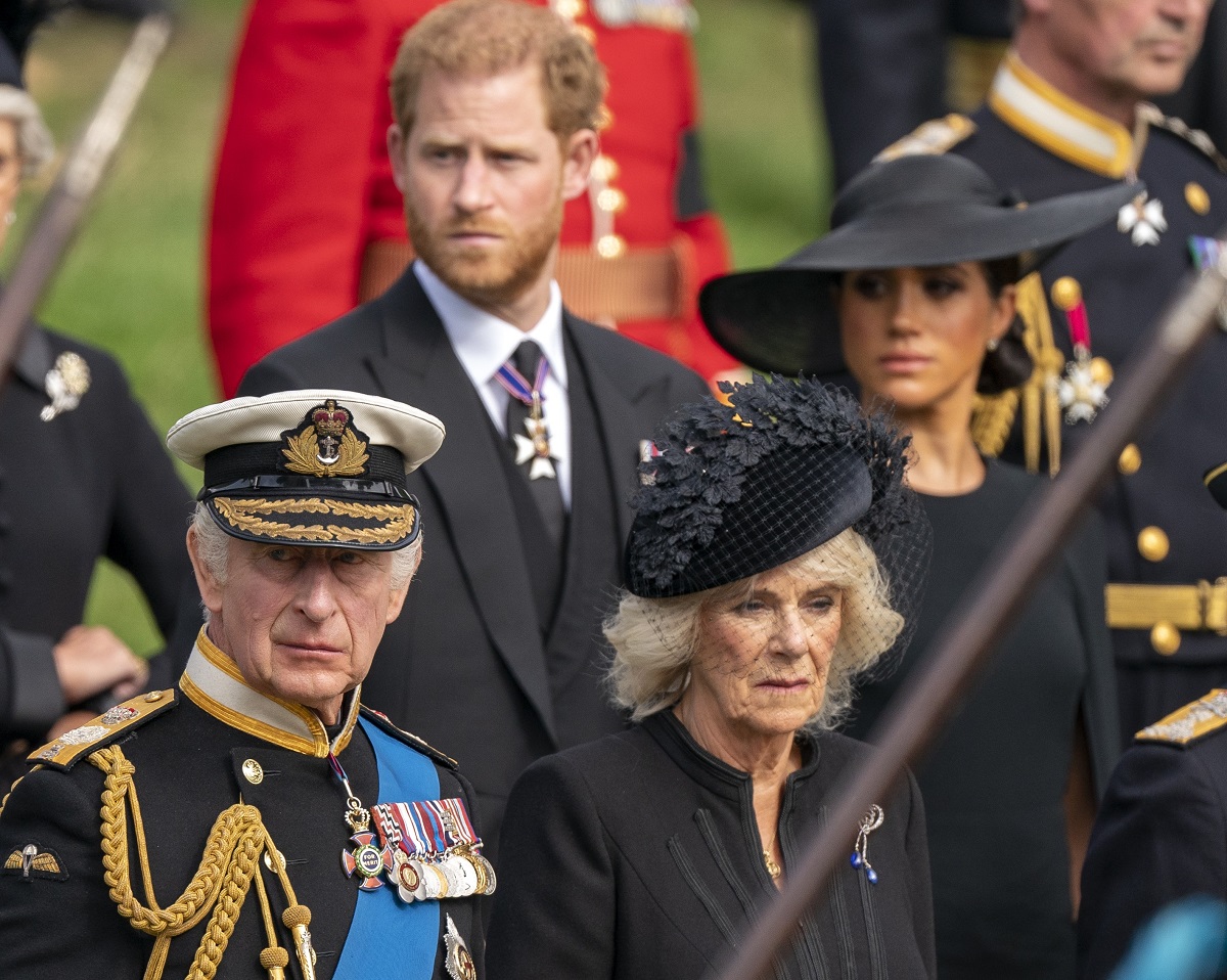 Prince Harry, Meghan Markle, King Charles III, and Camilla Parker Bowles look on at State Gun Carriage carrying the coffin of Queen Elizabeth II