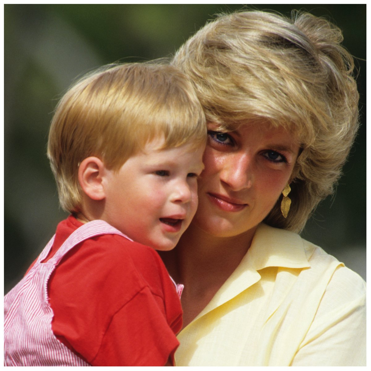 A photo of Princess Diana holding a young Prince Harry.