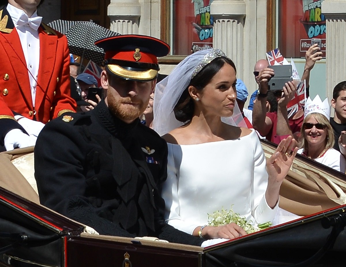 Prince Harry and Meghan Markle ride in a carraige outside of St. George's Chapel