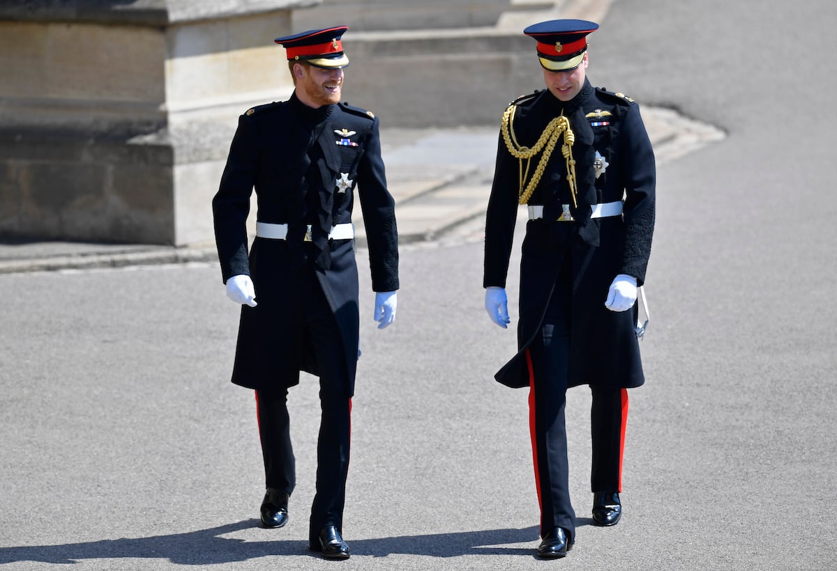 Prince Harry and Prince William, whose body language did a 'shift' from William's wedding to Harry's wedding, walk outside Windsor Castle