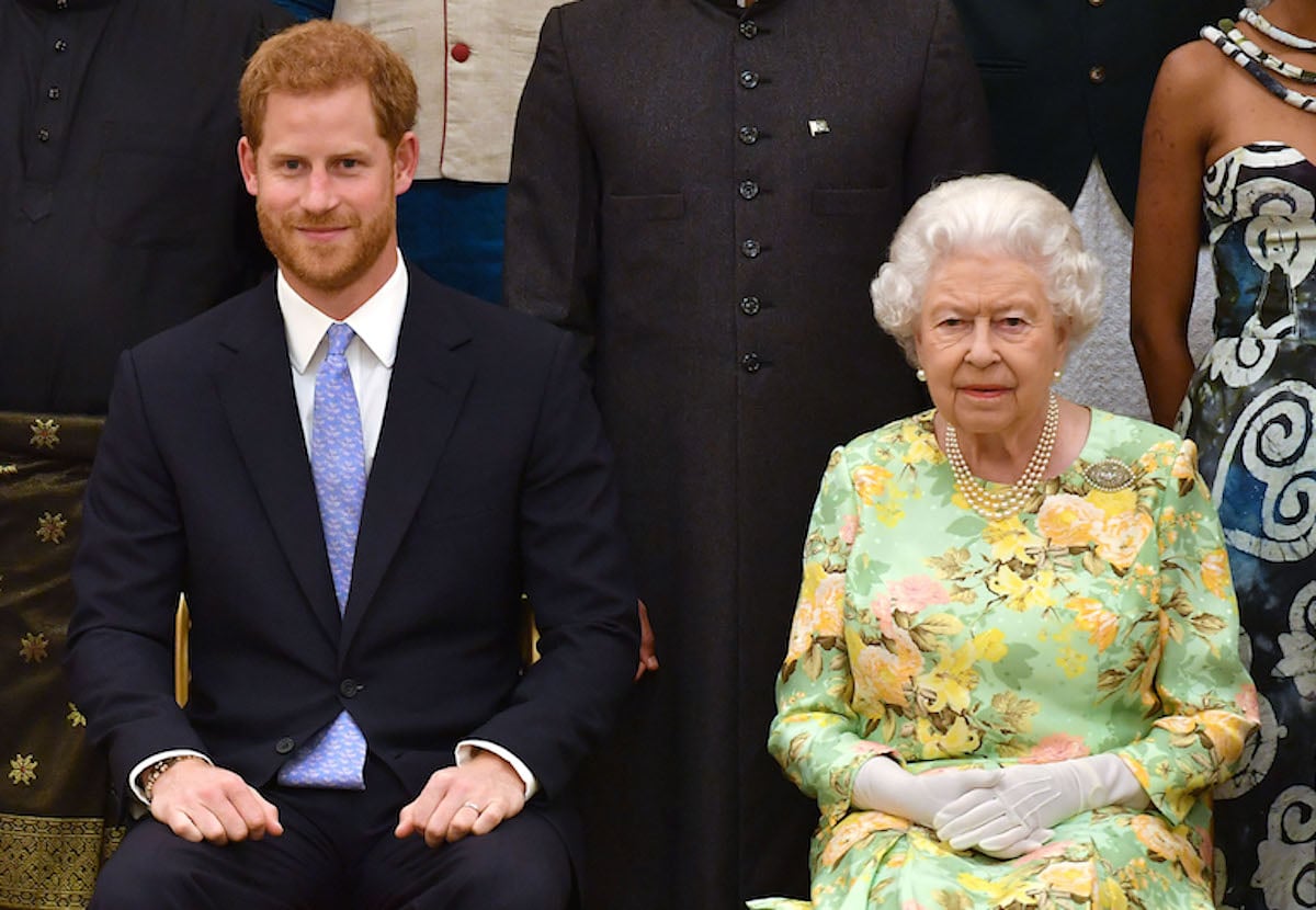 Prince Harry, who reportedly claimed in his 'Spare' memoir he never hugged Queen Elizabeth II but he wanted to, sits next to Queen Elizabeth II