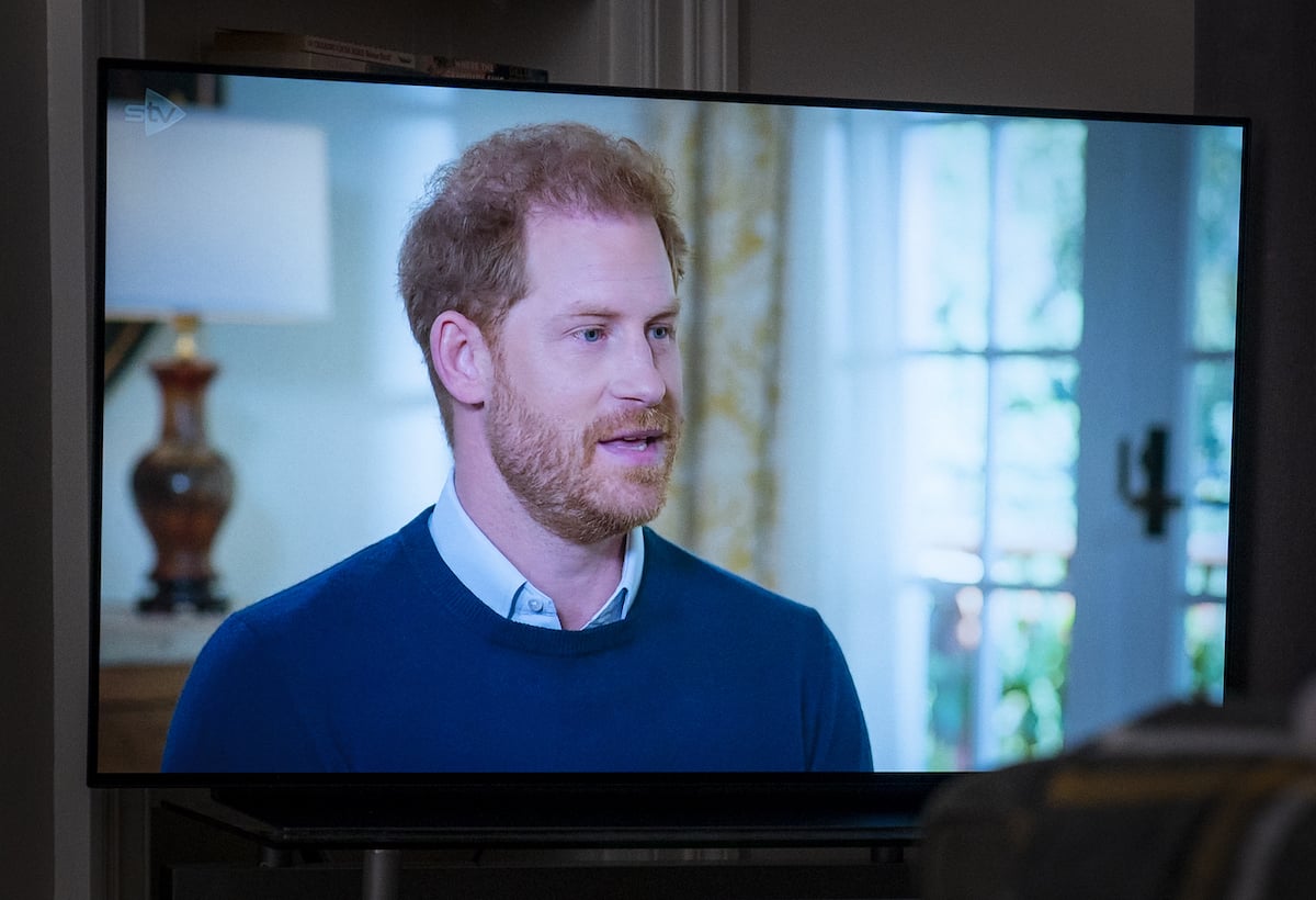 Prince Harry, who has received criticism for going too far in 'Spare' memoir by some, looks on wearing a blue shirt