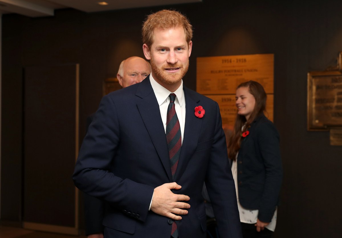 Prince Harry, who has received criticism for going too far in 'Spare' memoir, smirks wearing a suit