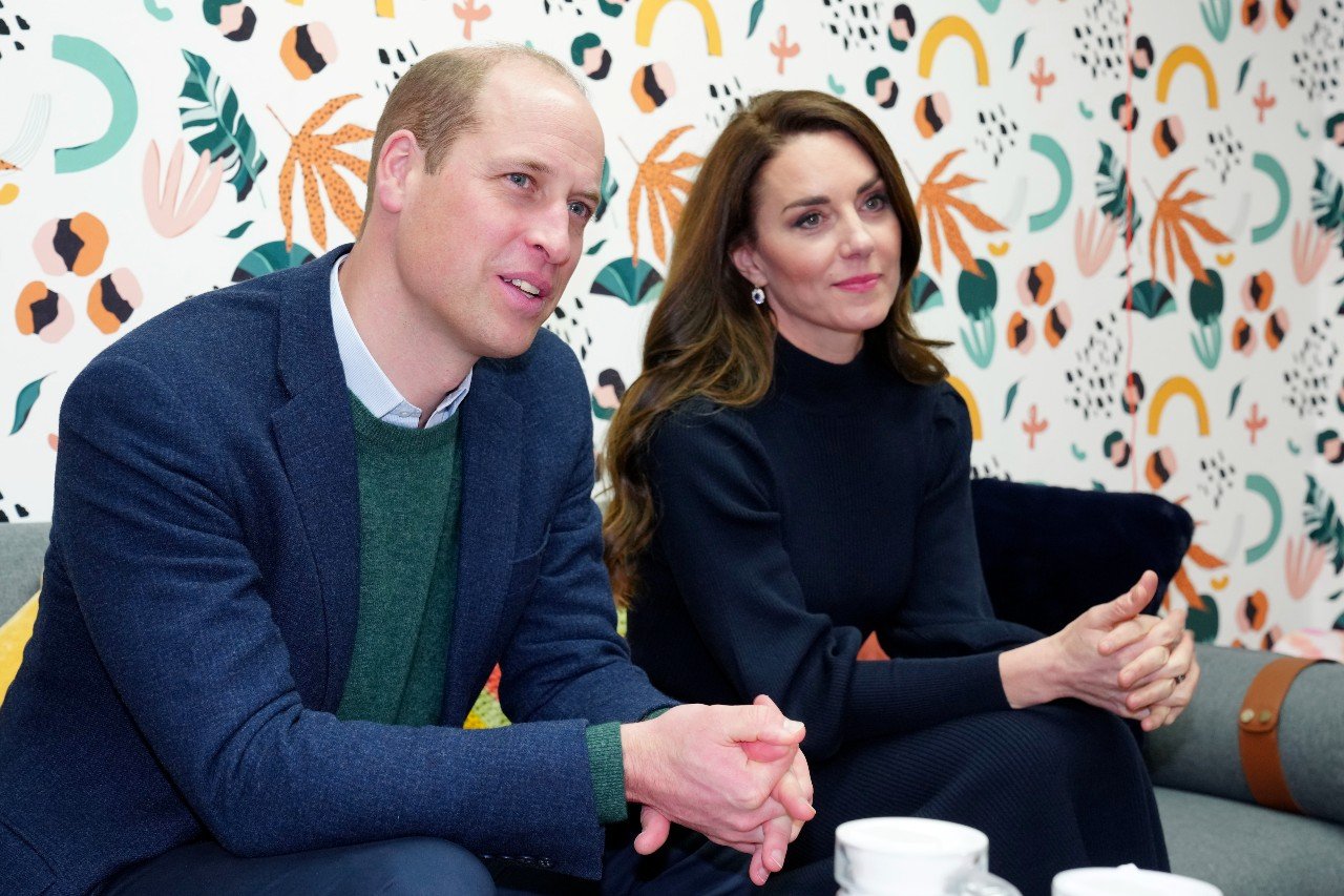 Prince William and Kate Middleton sit next to each other at an event.