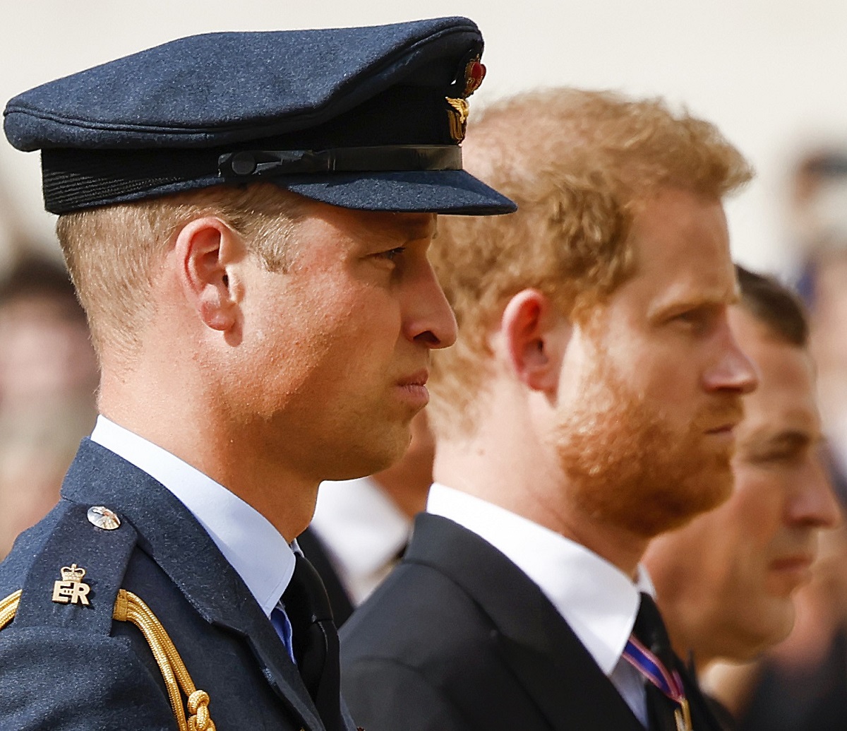 Prince William and Prince Harry, who a publisher says "contradicts" himself in 'Spare,' walk behind the coffin of Queen Elizabeth II during the procession for the Lying-in State