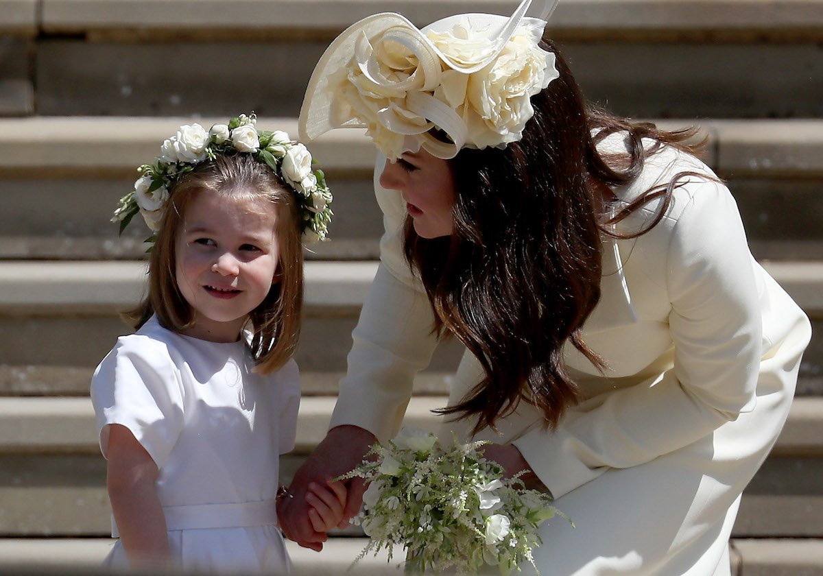 Princess Charlotte in a bridesmaid dress stands on the steps of St. George's Chapel during Prince Harry and Meghan Markle's royal wedding after flower girl dress drama per Prince Harry