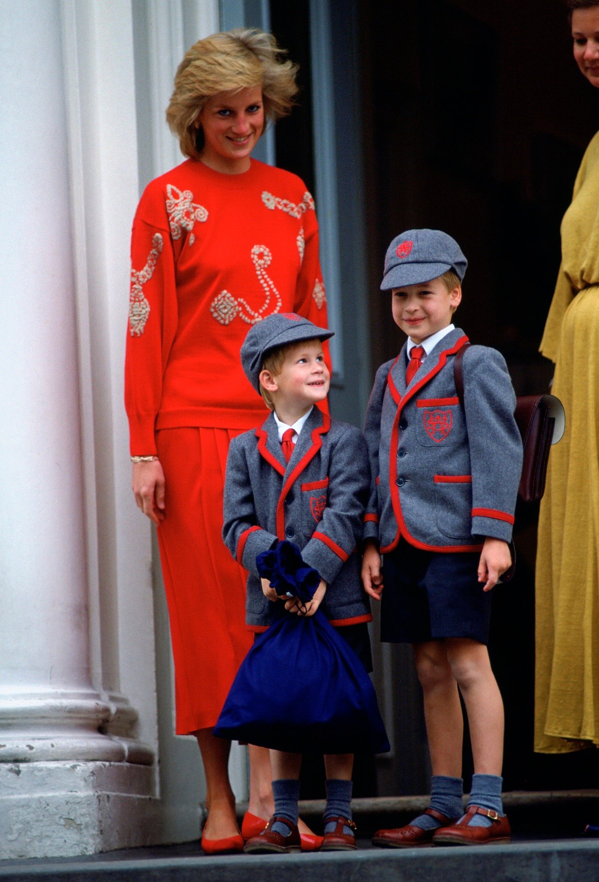 Princess Diana with Prince William and Prince Harry standing on the steps of Wetherby School