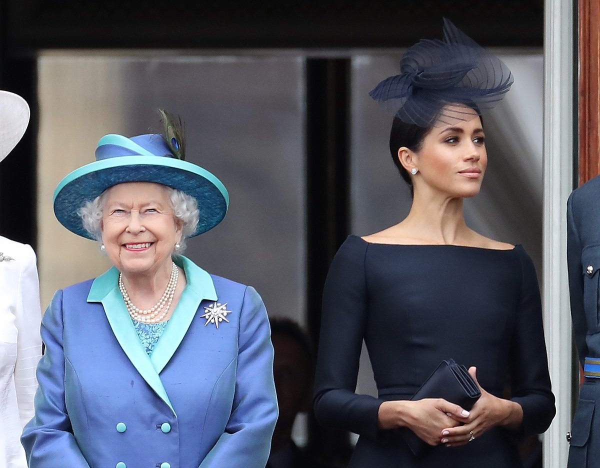 Queen Elizabeth II and Meghan on the balcony of Buckingham Palace as the Royal family attend events to mark the Centenary of the RAF in 2018