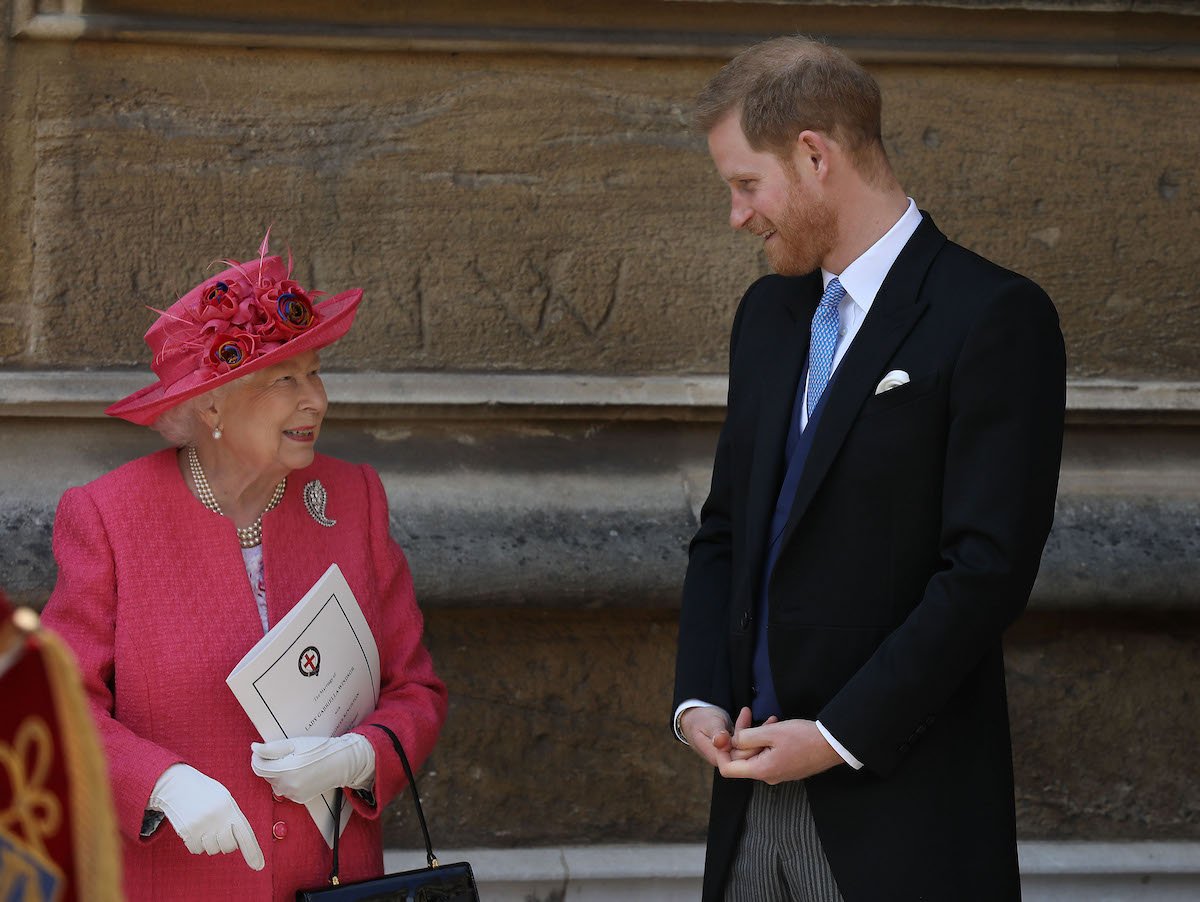Queen Elizabeth II and Prince Harry, who shared details of his last conversation with Queen Elizabeth II before her death in 'Spare', look at each other and smile.